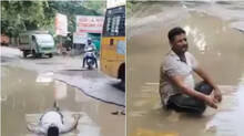 kanpur-man-lies-in-waterlogged-pothole-in-protest-after-daughter-slips