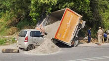 a-loaded-tipper-truck-overturned-on-top-of-a-car