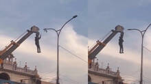 man-hangs-from-crane-to-rescue-bird-trapped-in-dangling-wires!